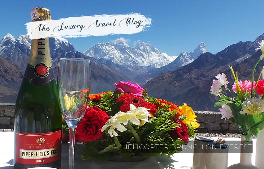 champagne, flowers on table, mt everest in background